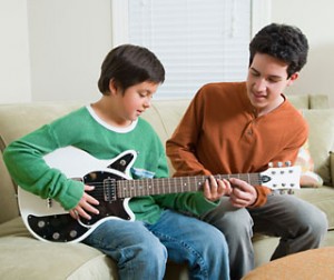 boy learning guitar